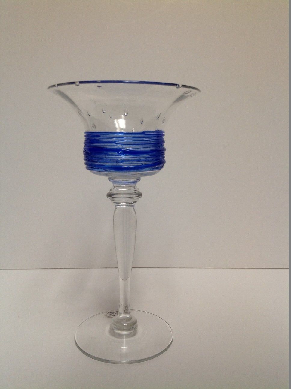 A clear glass with a blue stripe on it