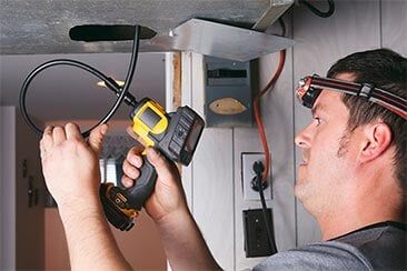 Worker cleaning ventilation - Duct Cleaning in Post Falls, ID Worker cleaning ventilation - Duct Cleaning in Post Falls, ID