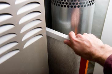 Worker Working On Central Heating Boiler - Heating in Post Falls, ID Worker Working On Central Heating Boiler - Heating in Post Falls, ID