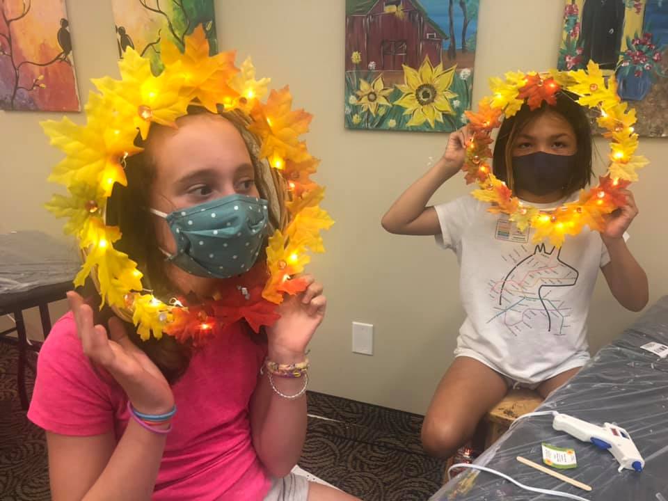 two girls with wreaths on their heads