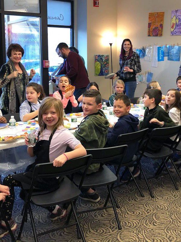 kids around painting table at birthday party