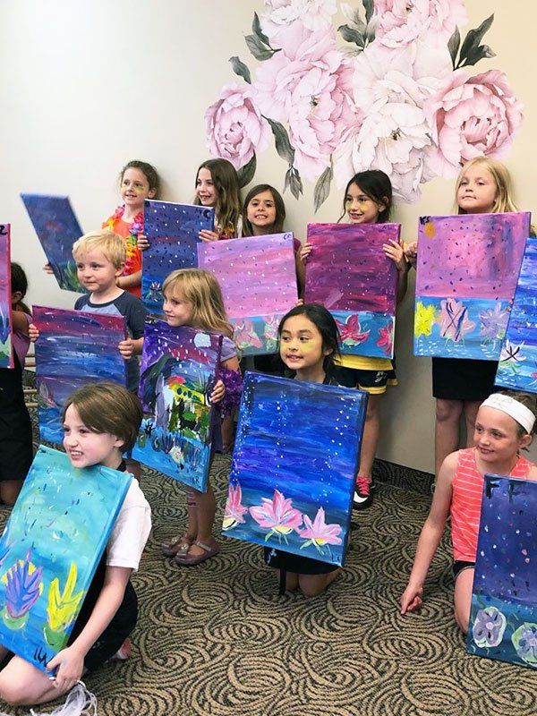 kids with their canvas paintings