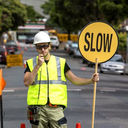 mildura traffic management a person holding sign board with slow sign 