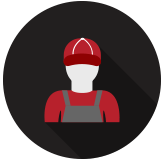 Mechanic wearing a red hat and overalls, in front of a dark gray background.