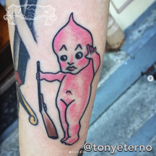 Pink cartoon flame character tattoo holding a bat, outlined in black on skin.