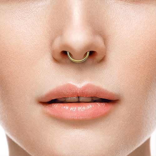 Close-up of lips and nose with a gold septum ring