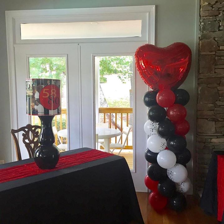 A loved themed balloon column with a heart at the top.