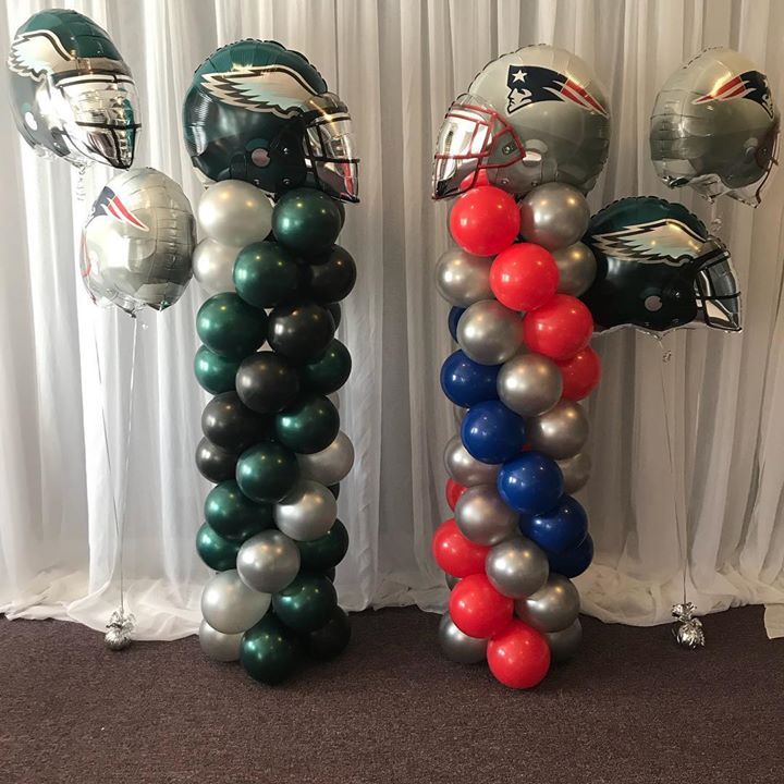 Balloon columns in the theme of the Philadelphia Eagles and the New England Patriots.