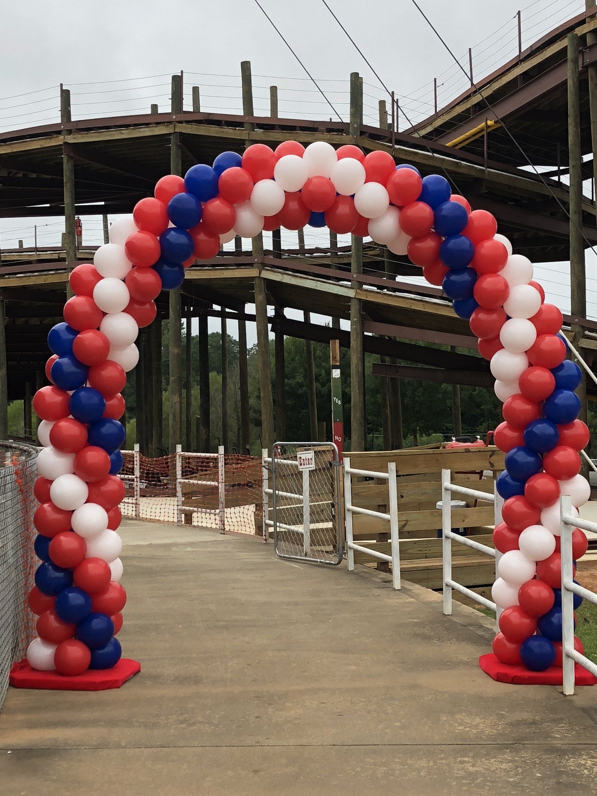 A spiraling red, white and blue balloon archway
