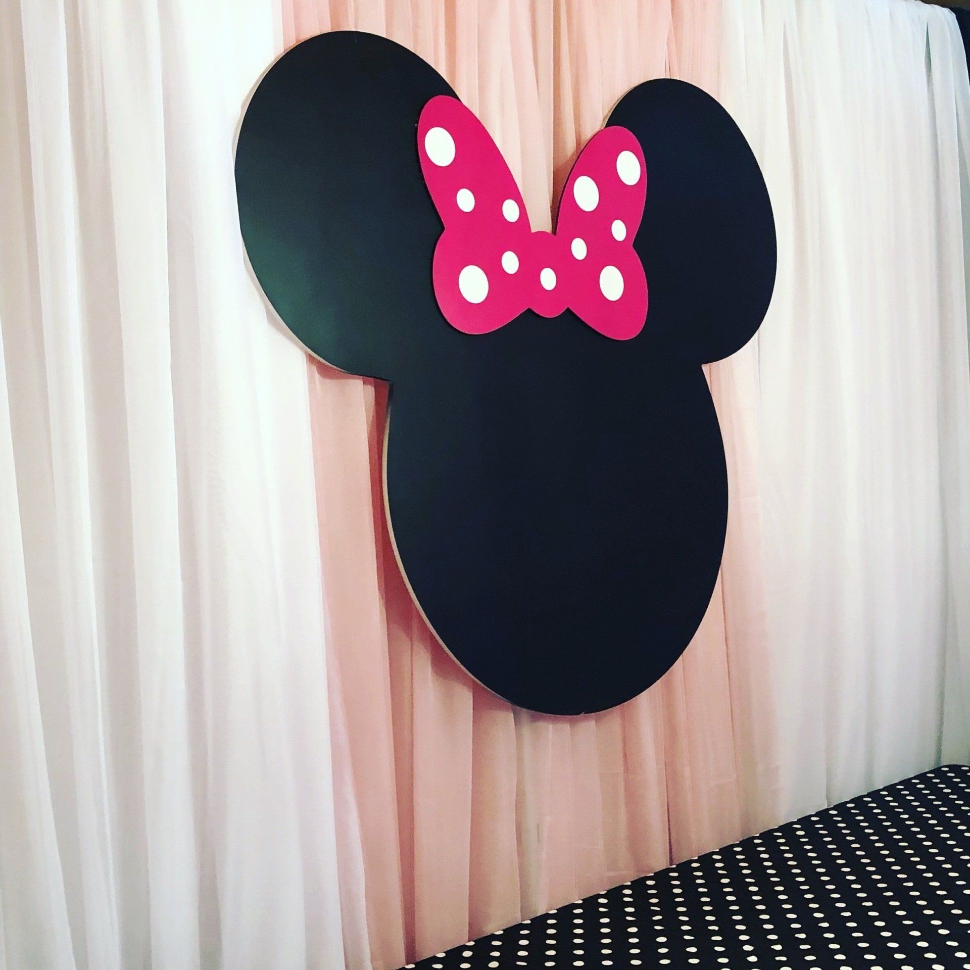 Minnie Mouse silhouette backdrop with pink bow for classic Disney themed girls birthday party decor