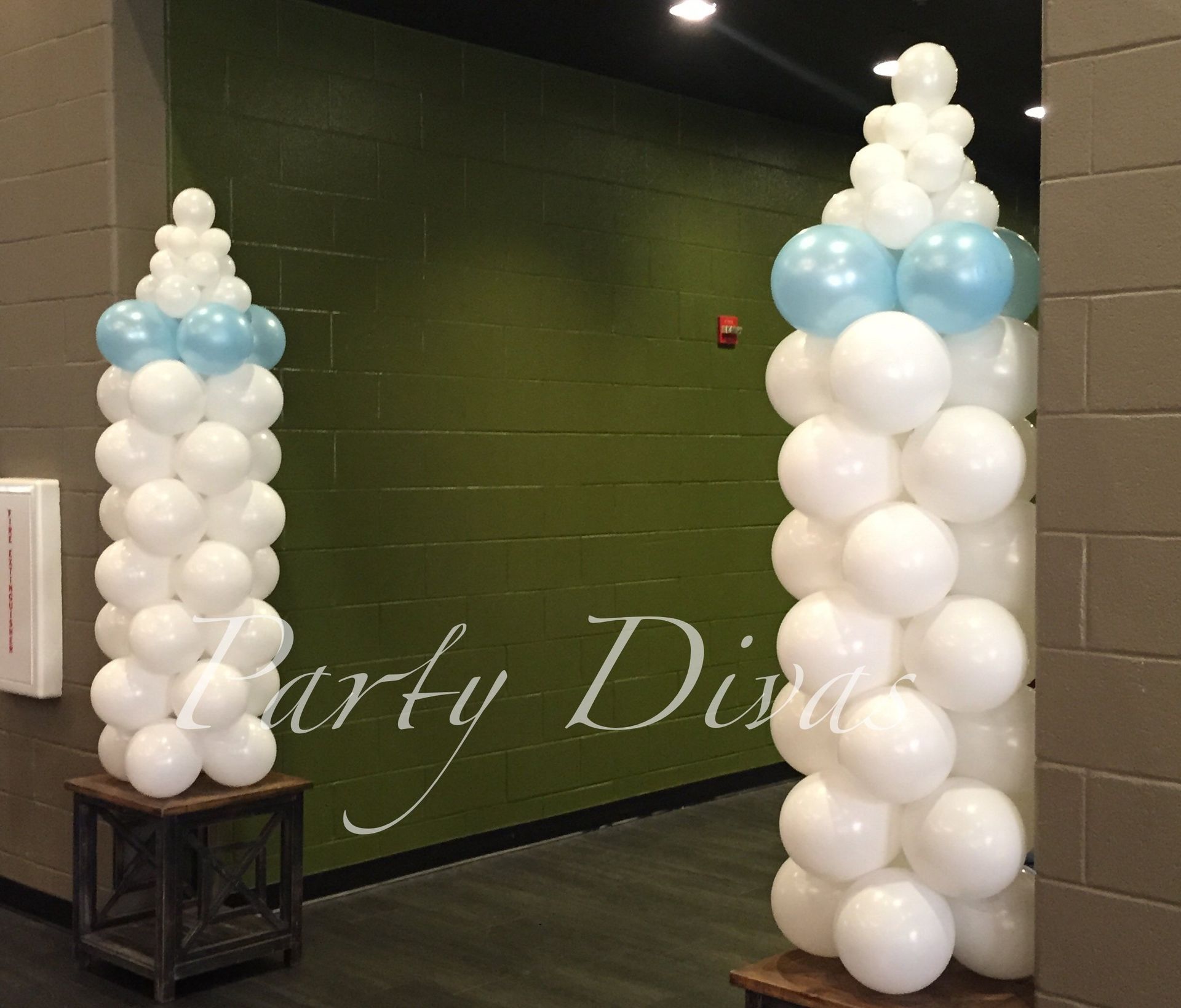 Two welcoming balloon columns created to look like baby bottles.