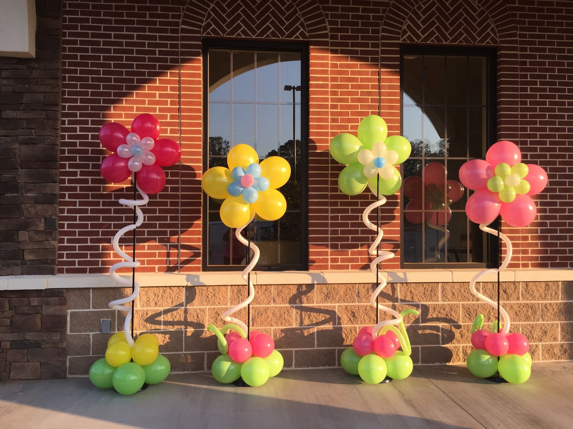 Four neat modern styled balloon columns in the theme of flowers.