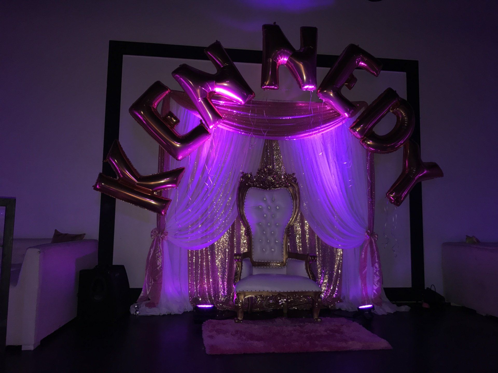 A throne with an elegant draped background and 