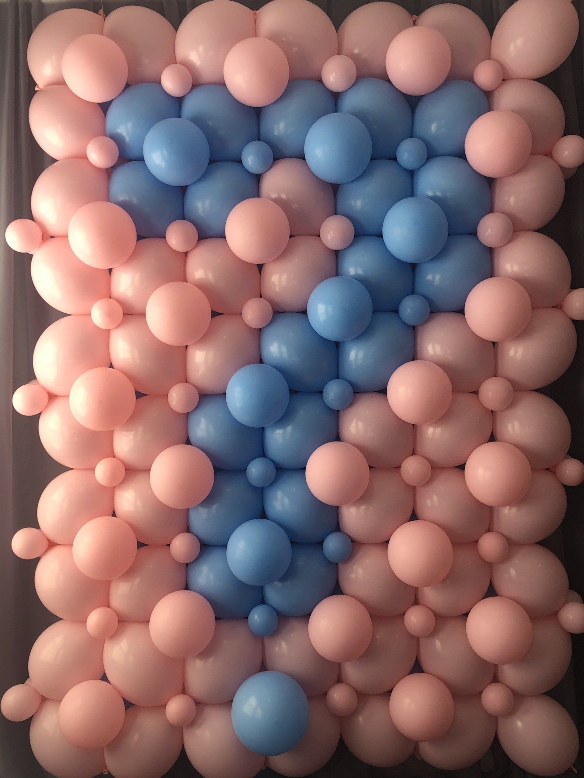 Pink and blue organic balloon wall backdrop for baby shower or gender reveal party
