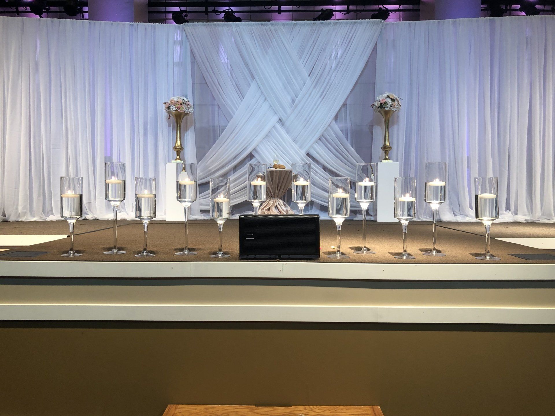 Modern white sheer drape canopy backdrop with soft lighting for minimalist wedding or event photo space