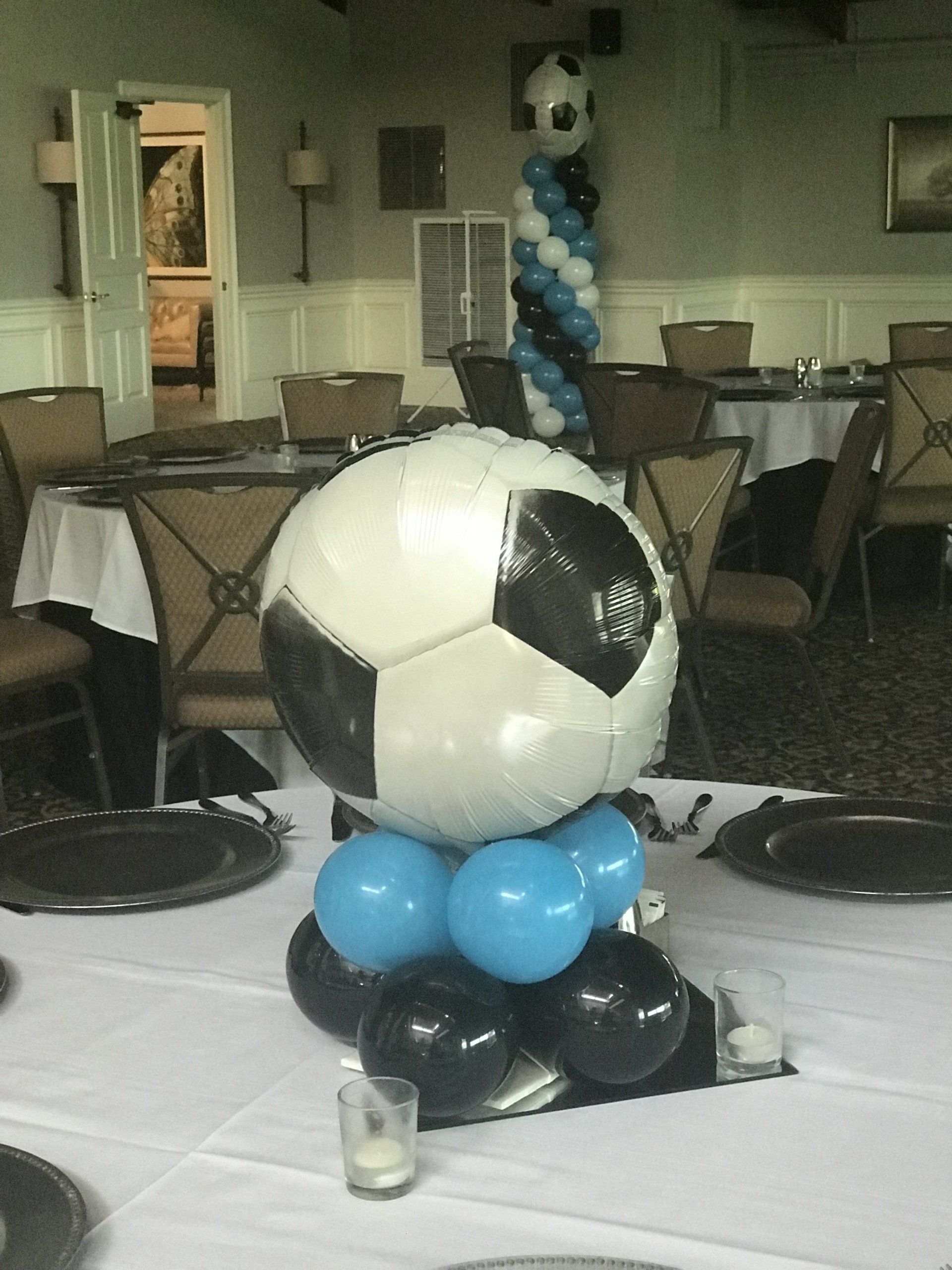 Indoor soccer themed balloon column with black and white soccer ball topper for sports party or team banquet