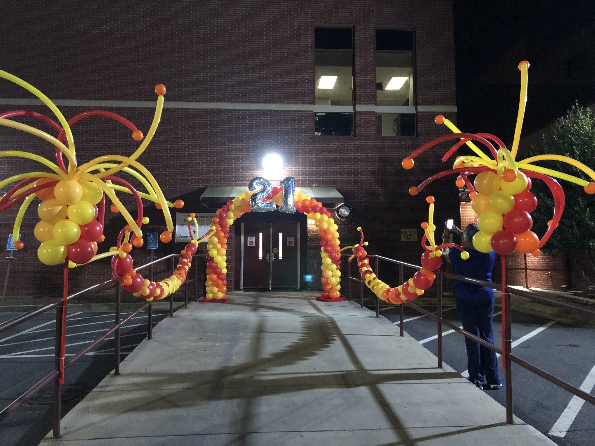 A welcome walkway adorned with balloon decorations and an archway with 