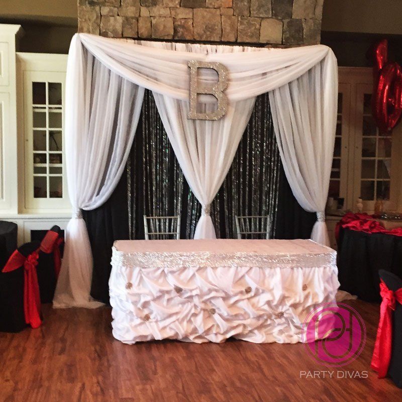 Three layered custom backdrop with a sparkling B initial at the top center for a head table