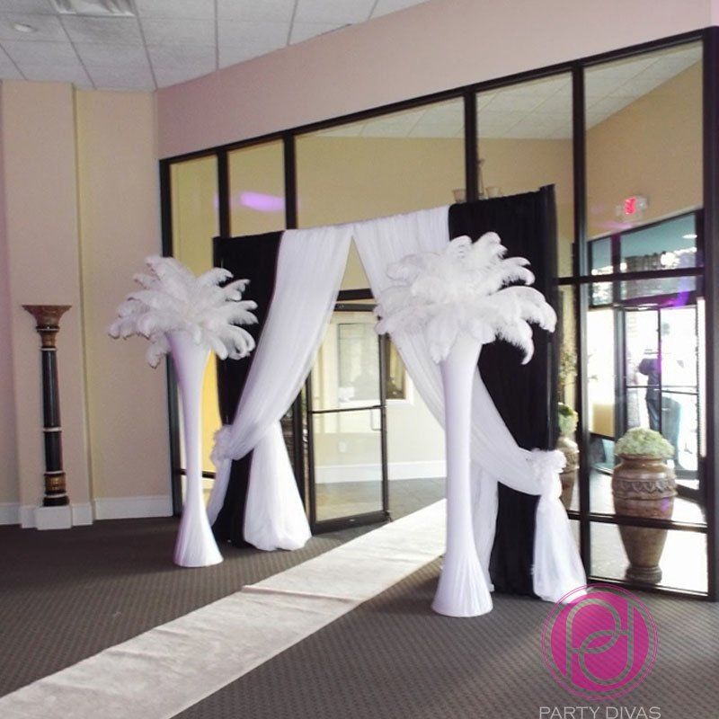 A welcoming entrance with custom draping and elegant tree props.