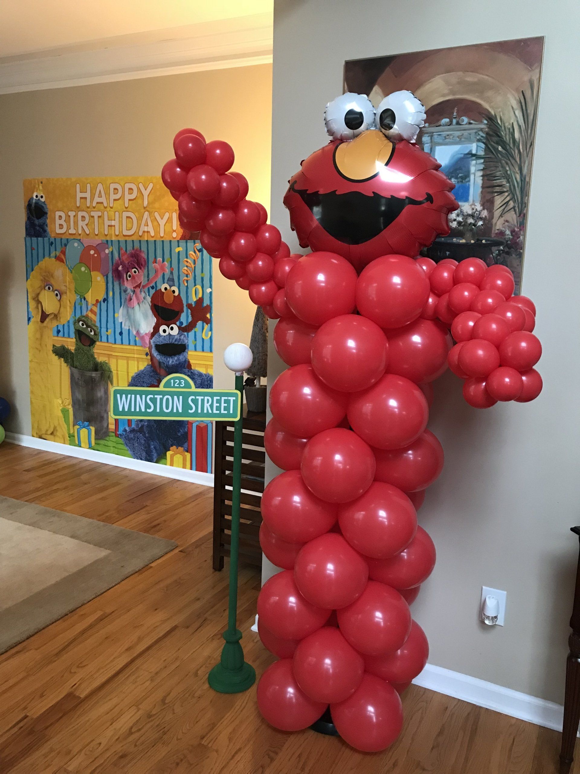 A balloon column created with red balloons to look like Elmo.