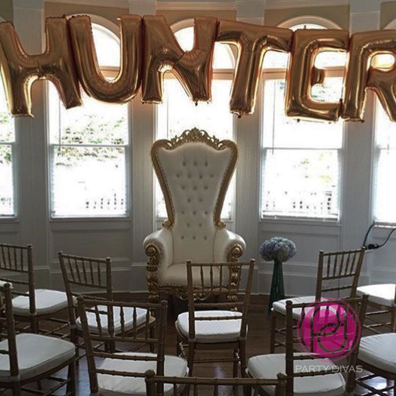 A throne sits in front of a set up of chairs with 