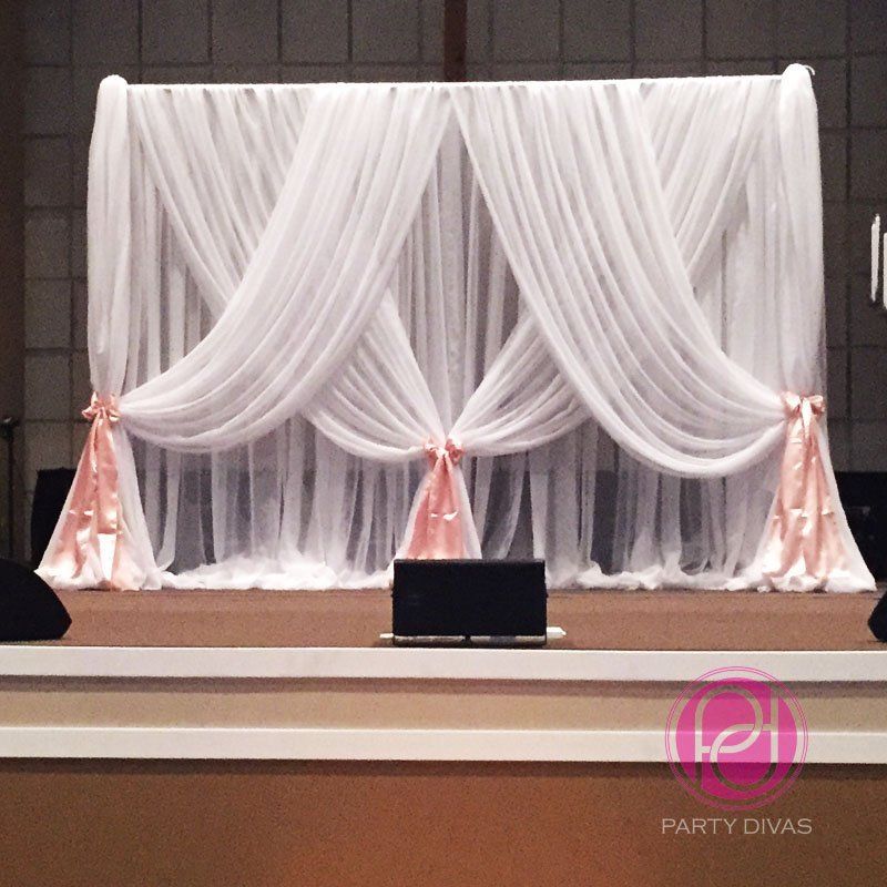 Beautiful draping for a stage backdrop with large bows at the tying points.