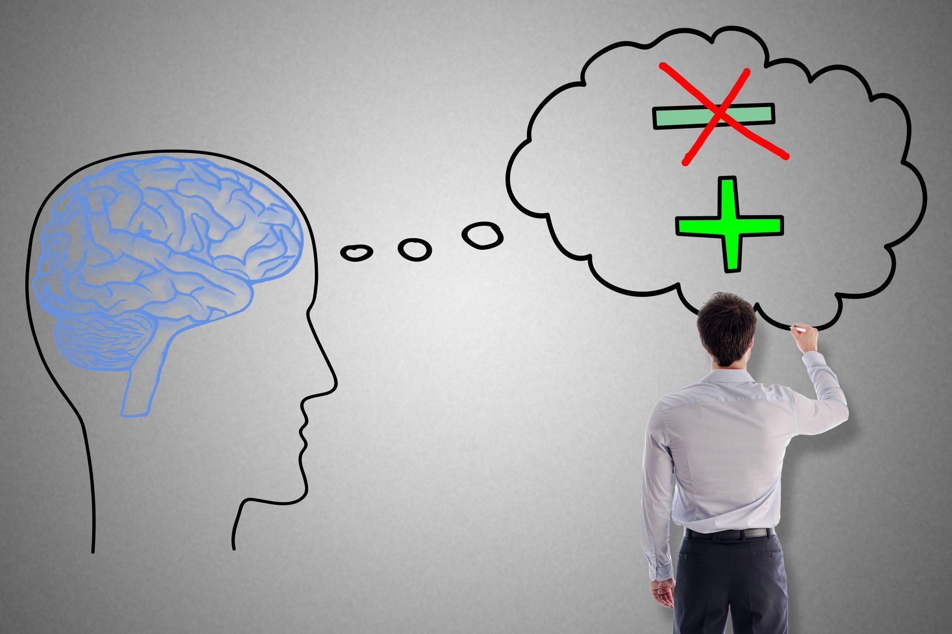 Man standing in front of a drawing of a brain.