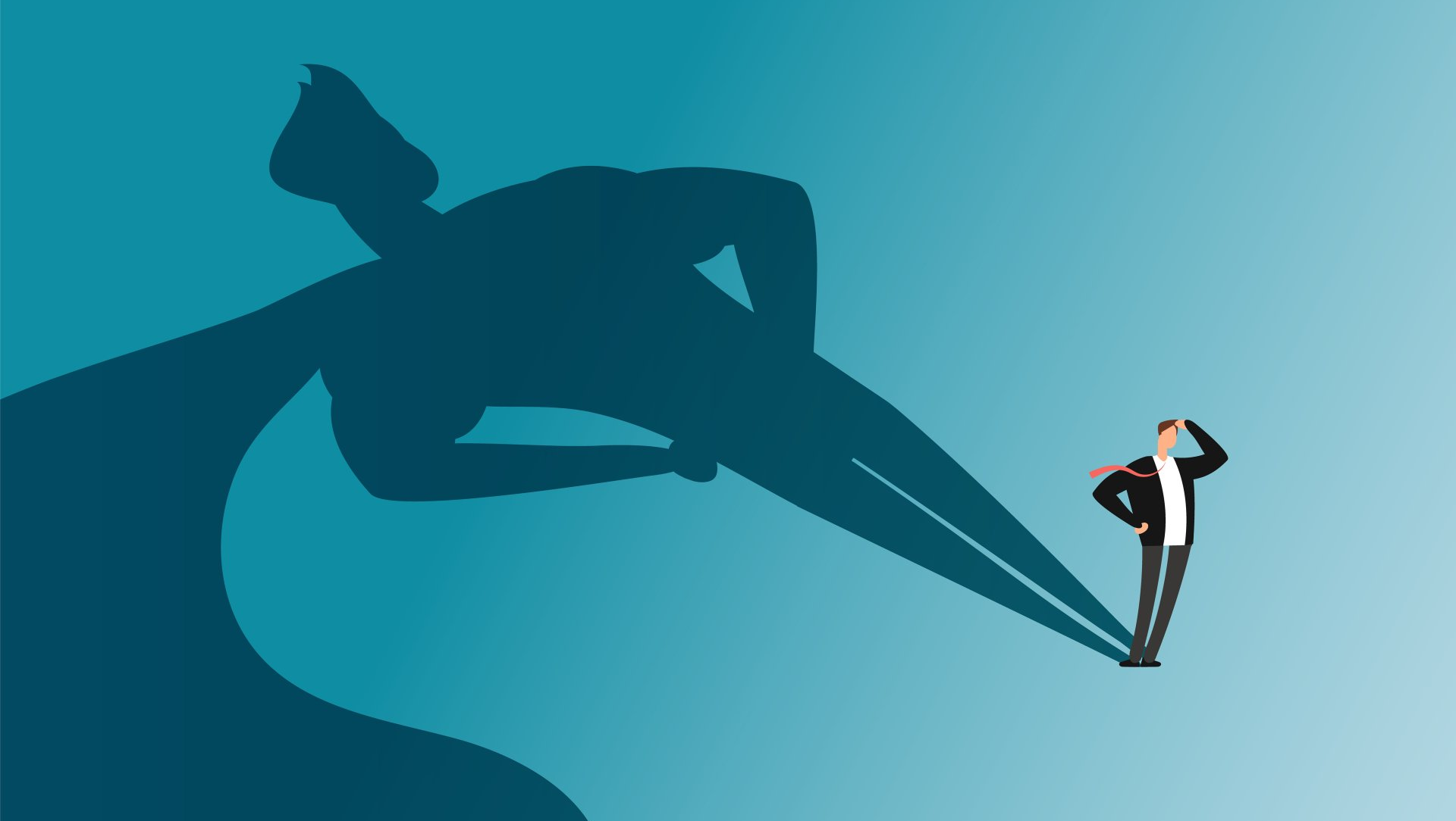 A man is standing in front of a shadow of a superhero.