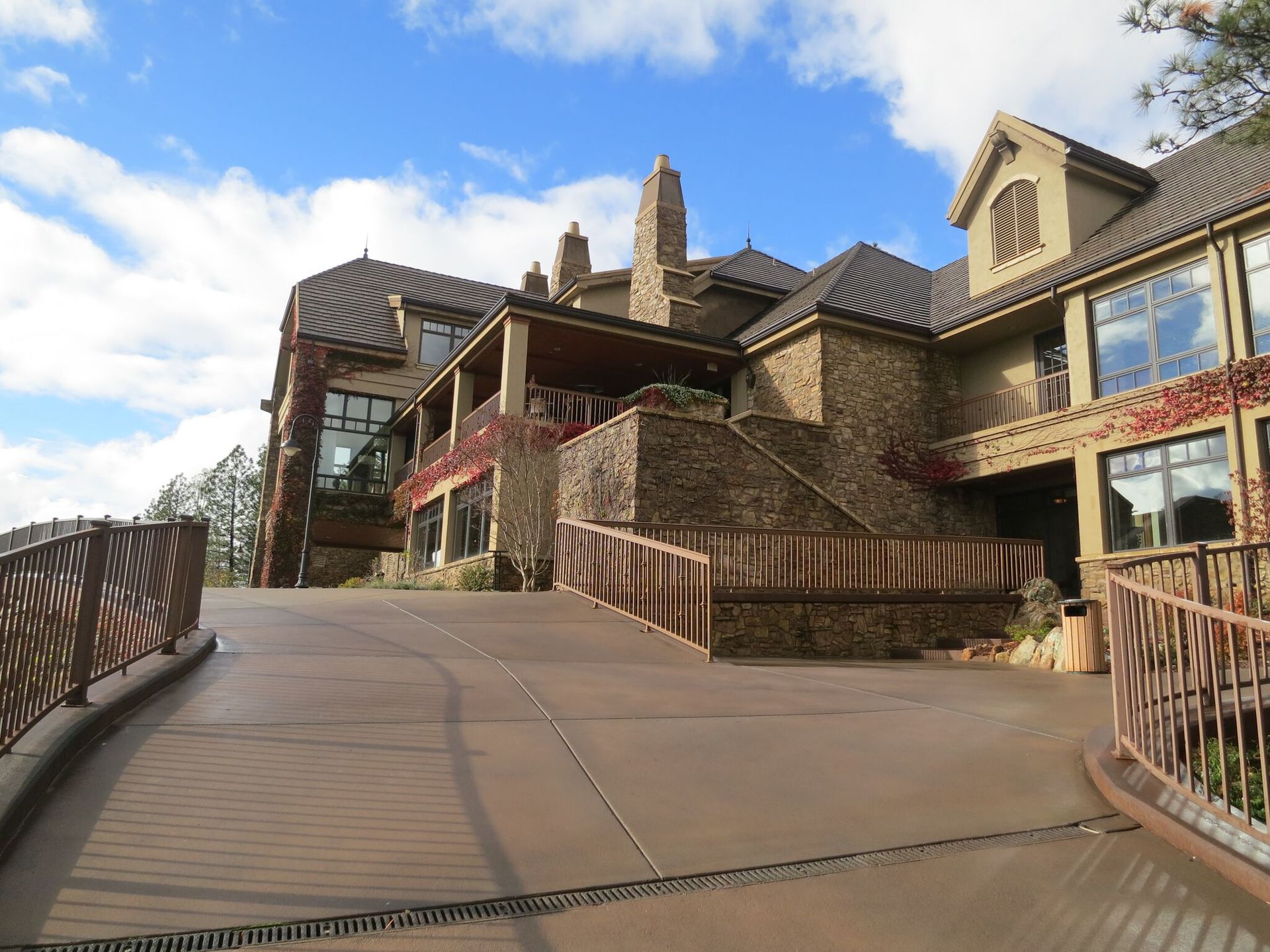 A large stone building with a wooden walkway leading to it.