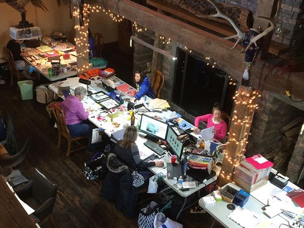 A group of people are sitting at tables with computers