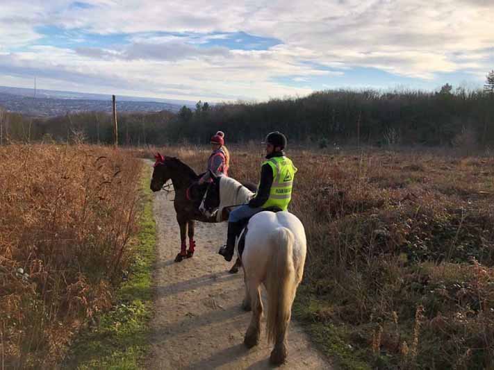 two people doing horse riding