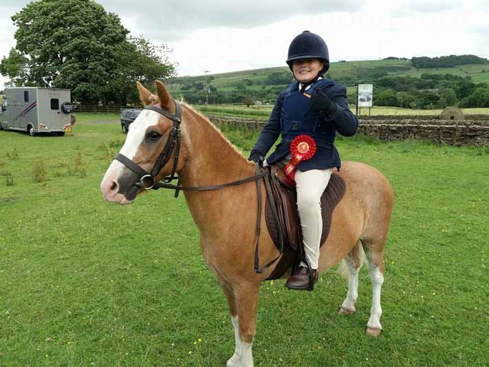 a child sit on horse