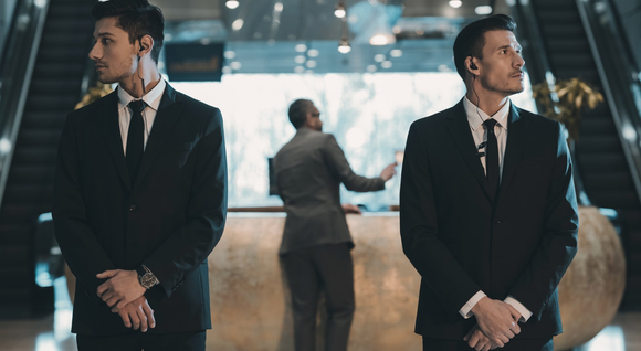 Security man check businessman at entrance in office building or airport