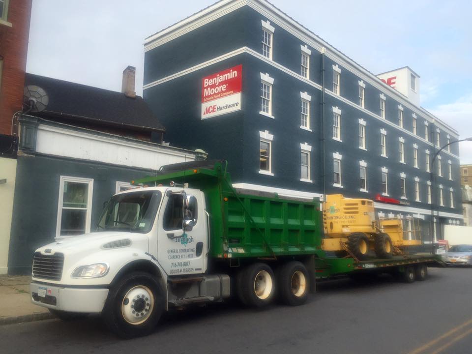 dump truck parked in front of building restoration site