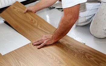 Man Installing Vinyl — Flooring Company in Gaithersburg, MD