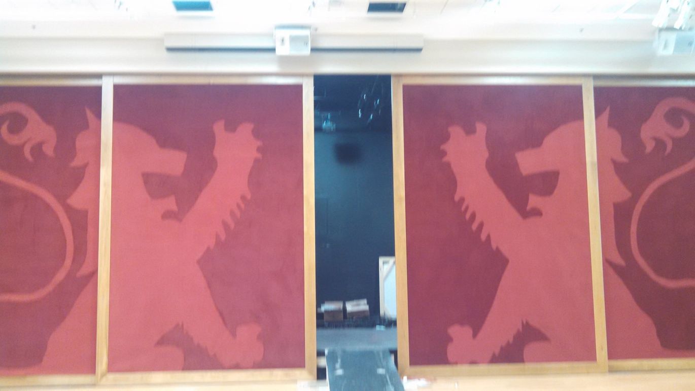 School mascot made from carpeting on stage doors
