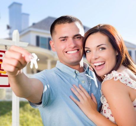 Military Couple in Front of a House — Title Services in Anoka, MN Military Couple in Front of a House — Title Services in Anoka, MN