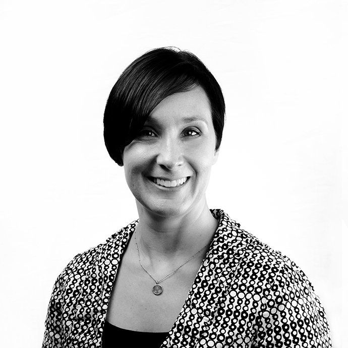 A woman is smiling in a black and white photo
