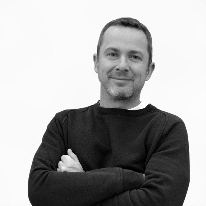 A man with his arms crossed is wearing a black sweater