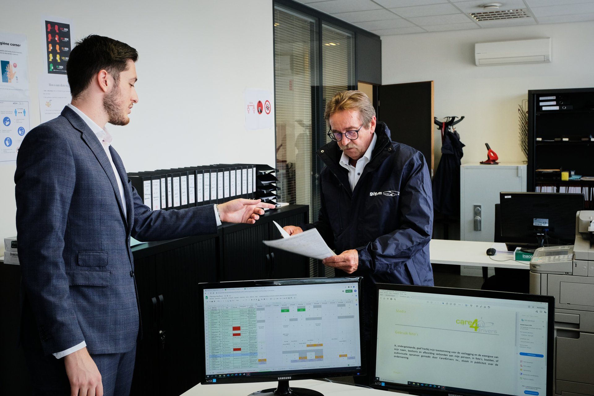 Photo of an administrative employee giving an assignment to a driver.