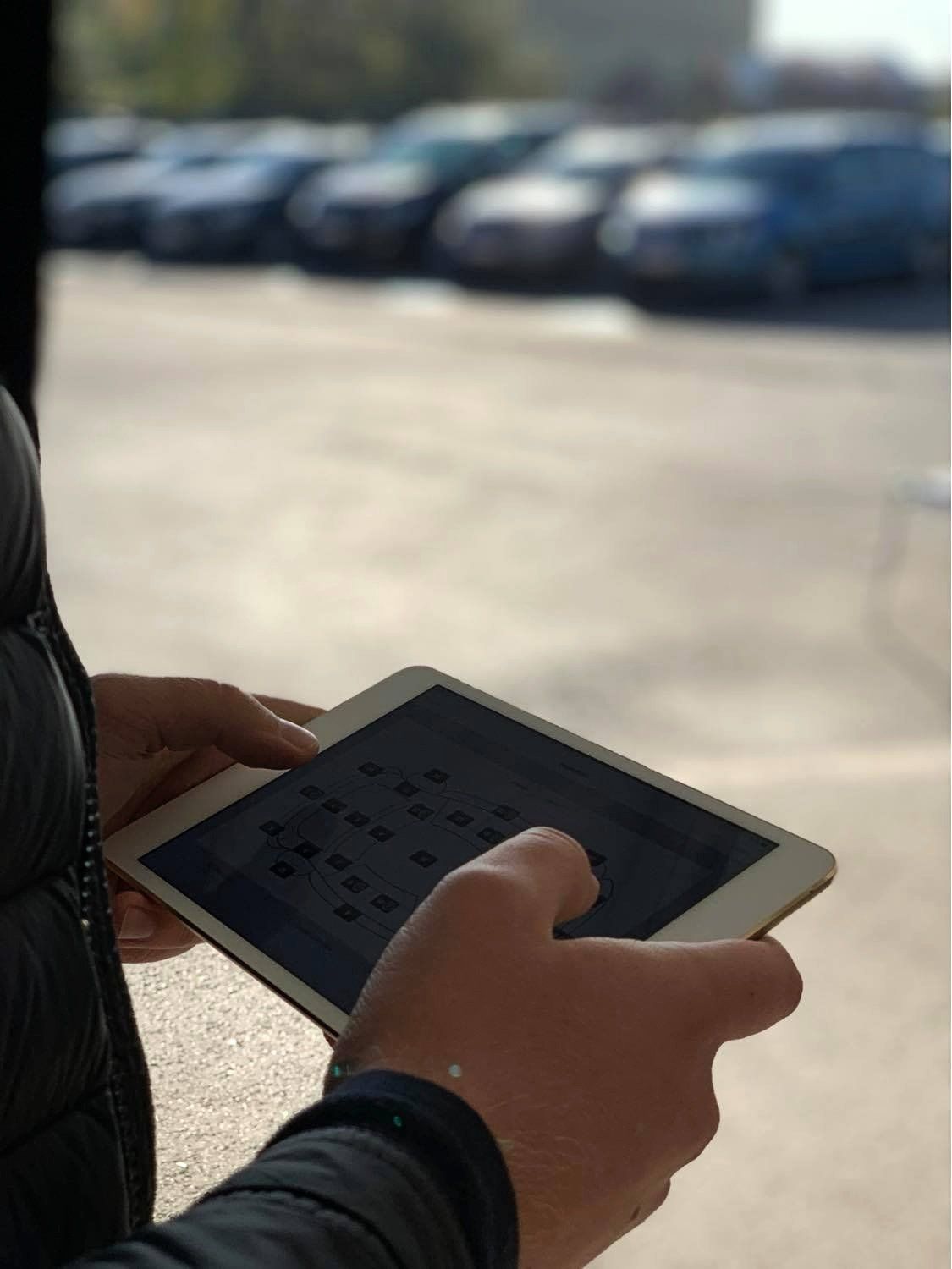Employee of  care for fleets making a damage review report on a tablet.