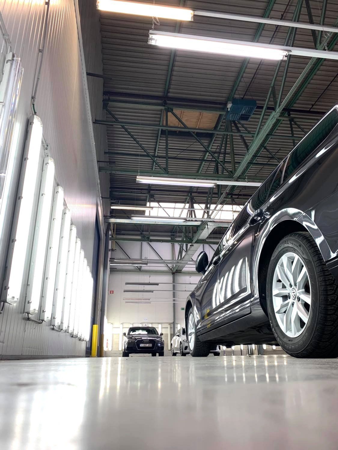 Photo of car ready for its damage review in a space with lots of lights.