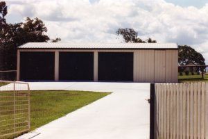 White outdoor garage with black doors