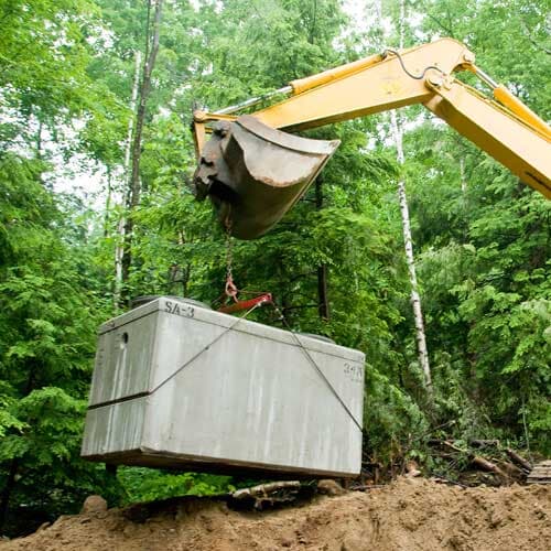 Installing Septic Tank with Excavator at Construction Site — Septic Service in Santa Maria, CA Installing Septic Tank with Excavator at Construction Site — Septic Service in Santa Maria, CA