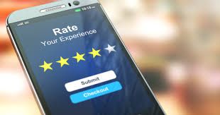 A close up of a cell phone with a five star rating on the screen.