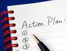 A pen is sitting on top of a notebook with the words action plan written on it.