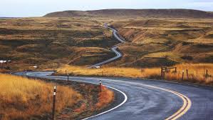A curvy road in the middle of a desert.