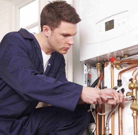 Commercial Boilers — Man Fixing the Boiler in Louisville, KY Commercial Boilers — Man Fixing the Boiler in Louisville, KY