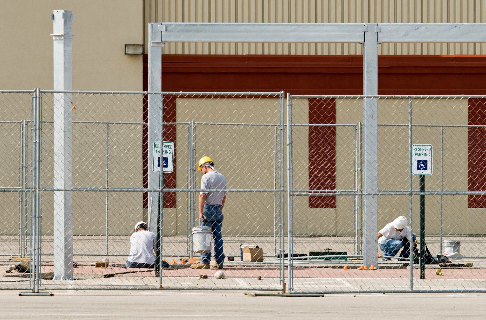 Worker Installing Chain Link Fence — Mobile, AL — Mobile Fence Worker Installing Chain Link Fence — Mobile, AL — Mobile Fence