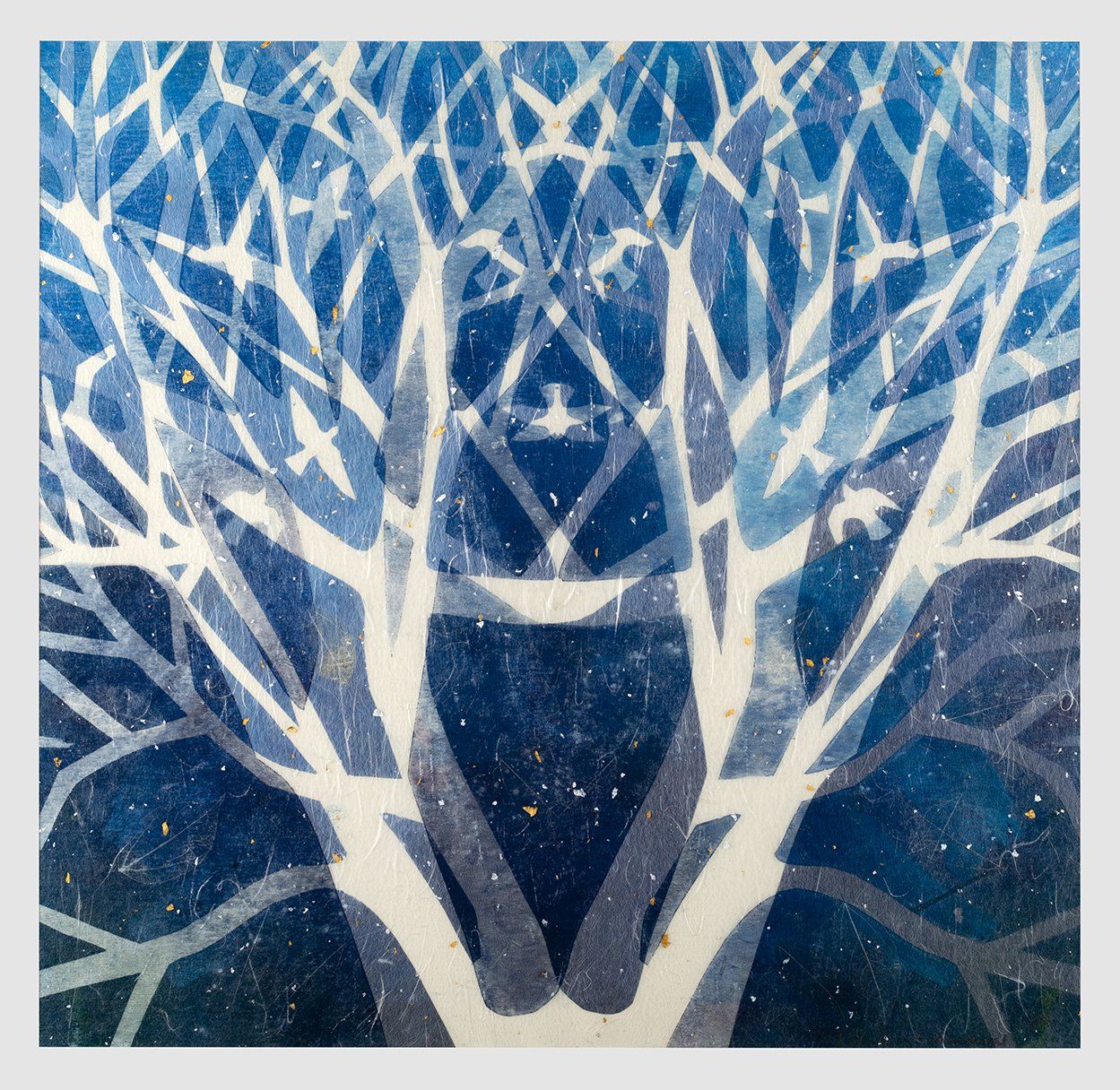 Symmetrical white tree branches against a dark blue background, possibly a winter night.